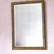 Rectangular gold mirror with bevelled glass.