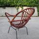 Rattan shell armchair with metal feet