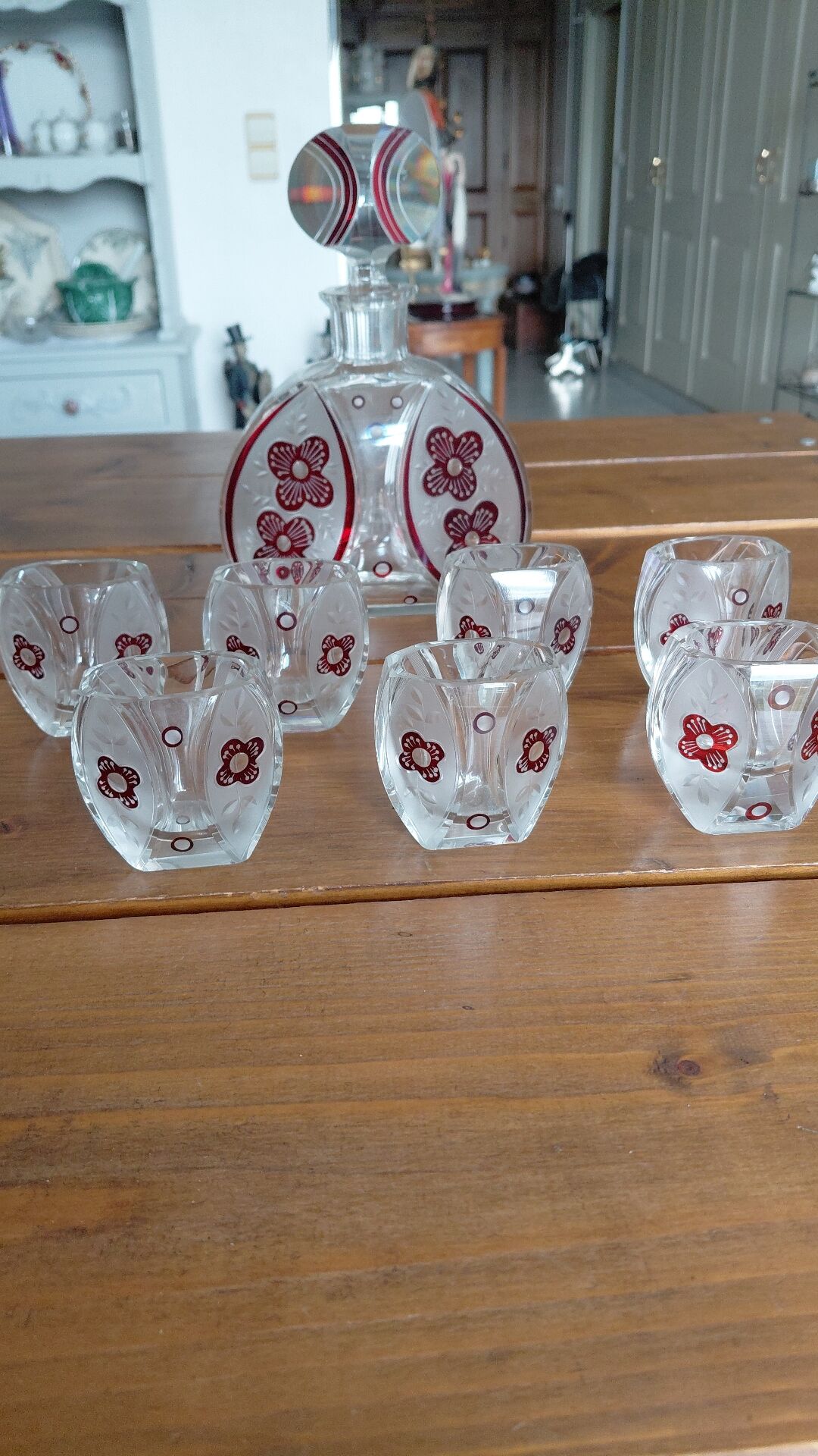 Vintage liqueur service in decorated red glass – decanter and 7 glasses