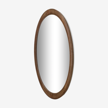 Oval beveled mirror surrounded by light wood dimension: height -74,5cm- width -38,5cm- prof-2cm-
