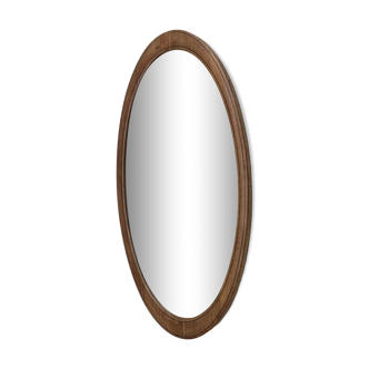 Oval beveled mirror surrounded by light wood dimension: height -74,5cm- width -38,5cm- prof-2cm-