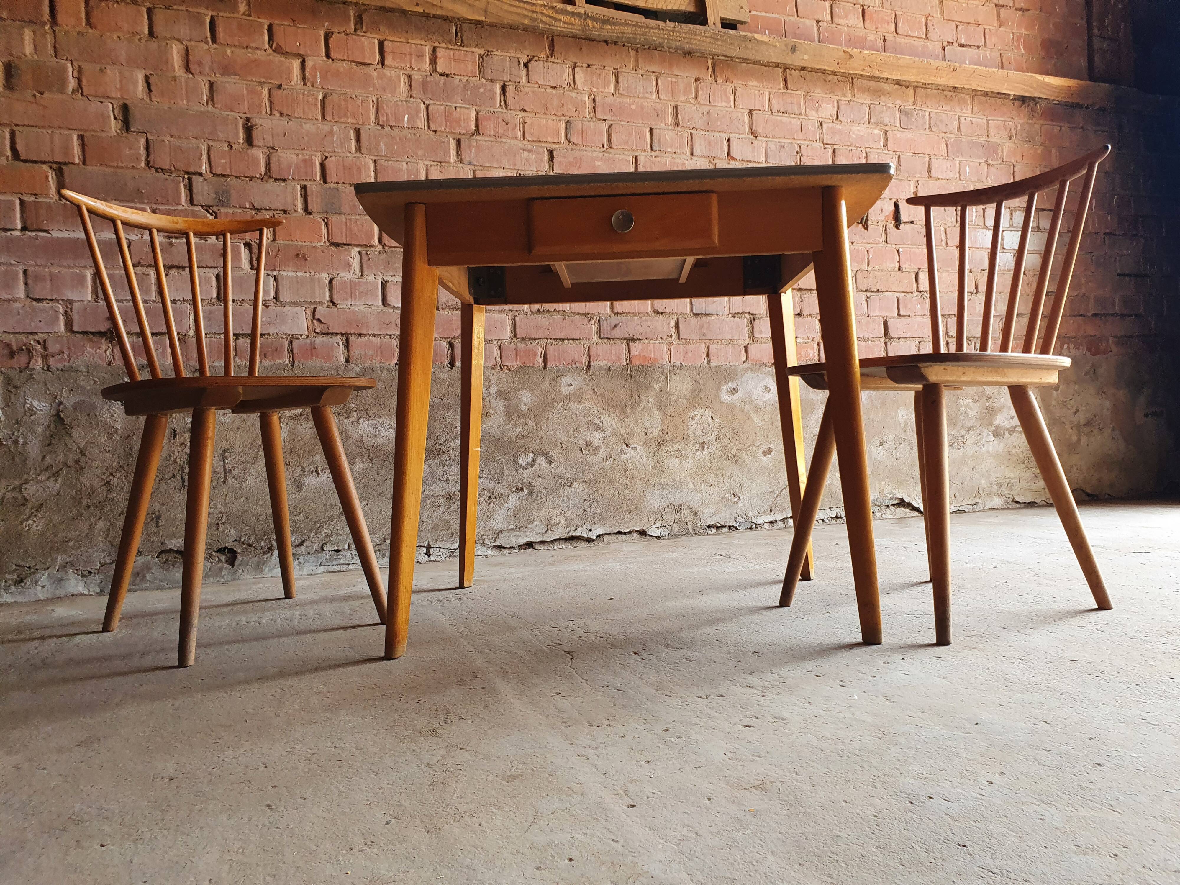 Together two Scandinavian chairs and its wooden and formica table