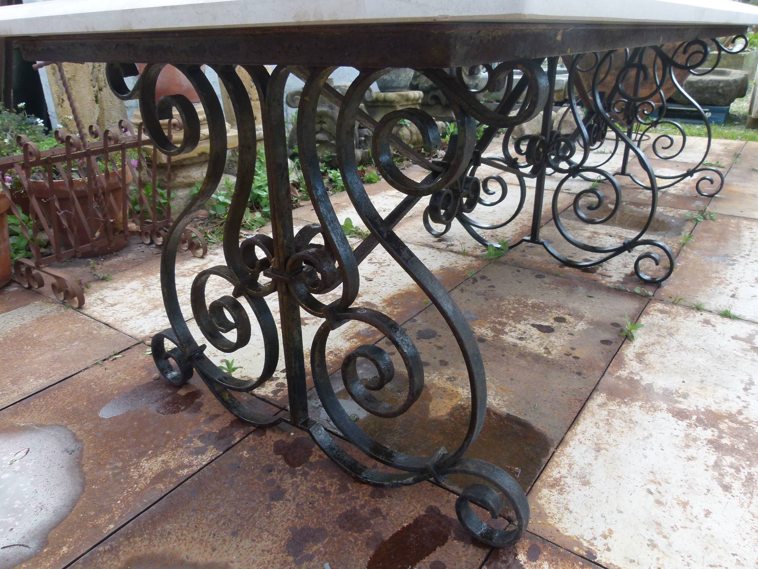 Marble table with wrought iron legs.