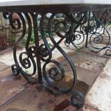 Marble table with wrought iron legs.