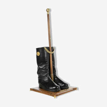 Boots on their wooden and brass support