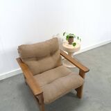 Brown-grey armchair with an oak frame.