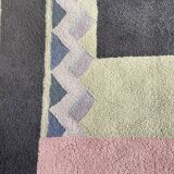 Hand-knotted wool rug by Tisca with a geometric pattern, signed "ILES", France, 1990s.