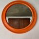 Mirror with round frame in orange molded plastic by carrara & matta, 1974