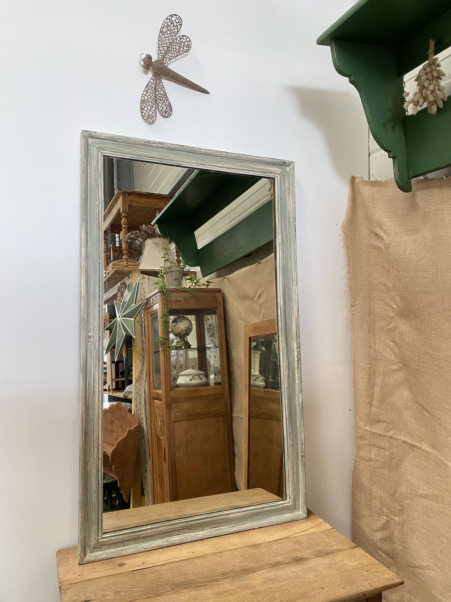 Antique mirror with a green and white patina.