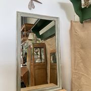 Antique mirror with a green and white patina.