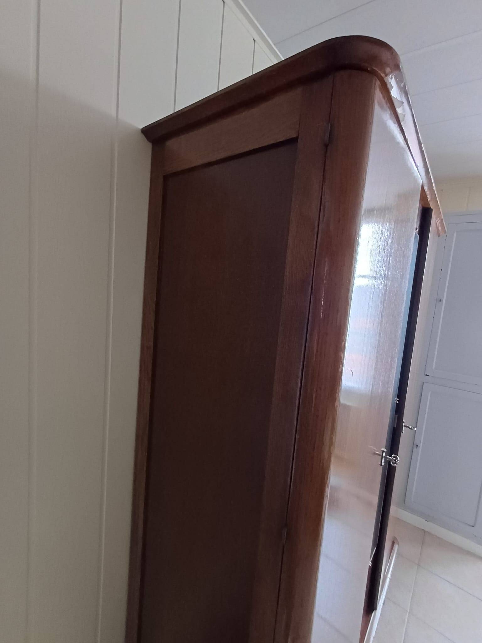 Vintage 1960s wooden wardrobe with a central mirror and tapered legs.