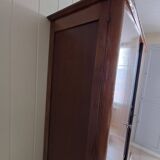 Vintage 1960s wooden wardrobe with a central mirror and tapered legs.