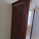 Vintage 1960s wooden wardrobe with a central mirror and tapered legs.