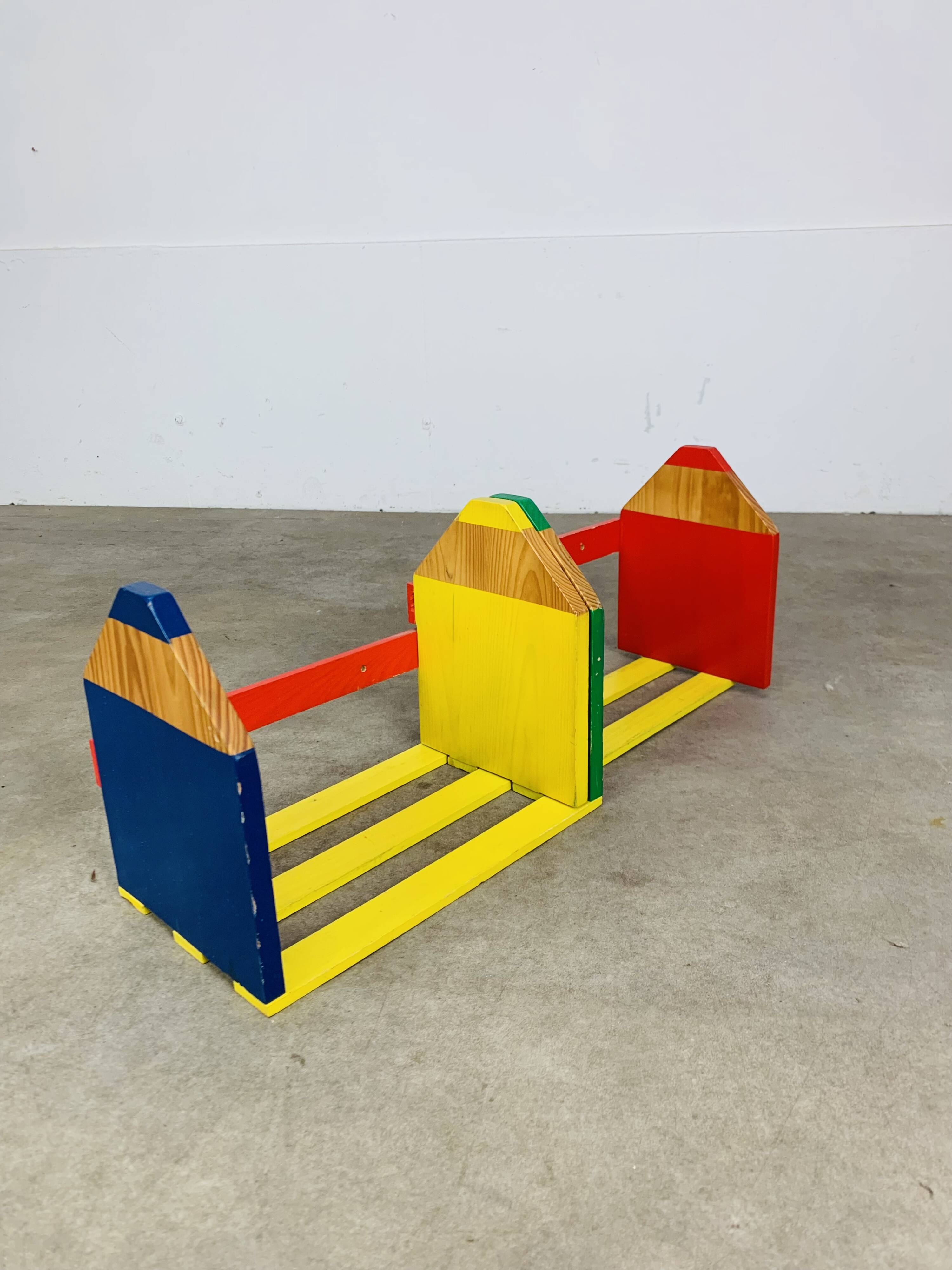 Modular wall-mounted pencil shelf in Pierre Sala style, for children.