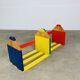 Modular wall-mounted pencil shelf in Pierre Sala style, for children.
