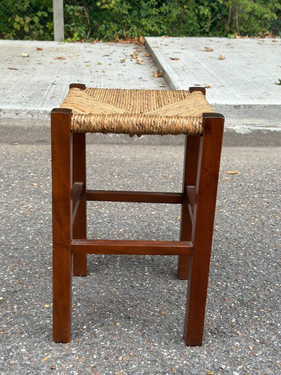 Low stool in brutalist style made of solid wood with straw, 1980.
