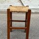 Low stool in brutalist style made of solid wood with straw, 1980.