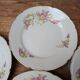 7 dessert plates in porcelain with a violet lilac design and a gold rim.