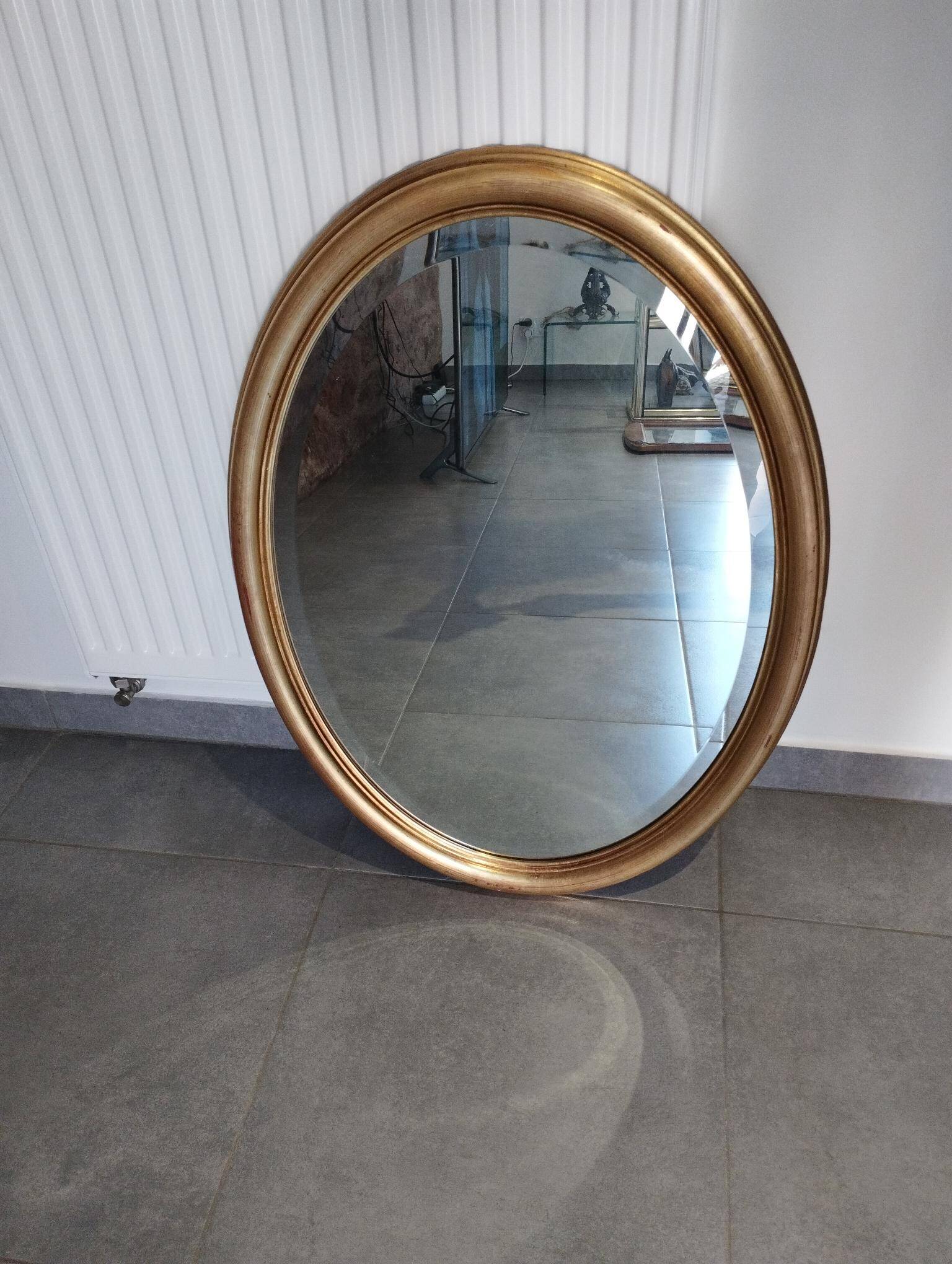Grand et élégant miroir doré ovale avec sa glace biseauté