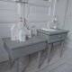 Duo of bedside tables, mismatched vintage sofa ends green of gray