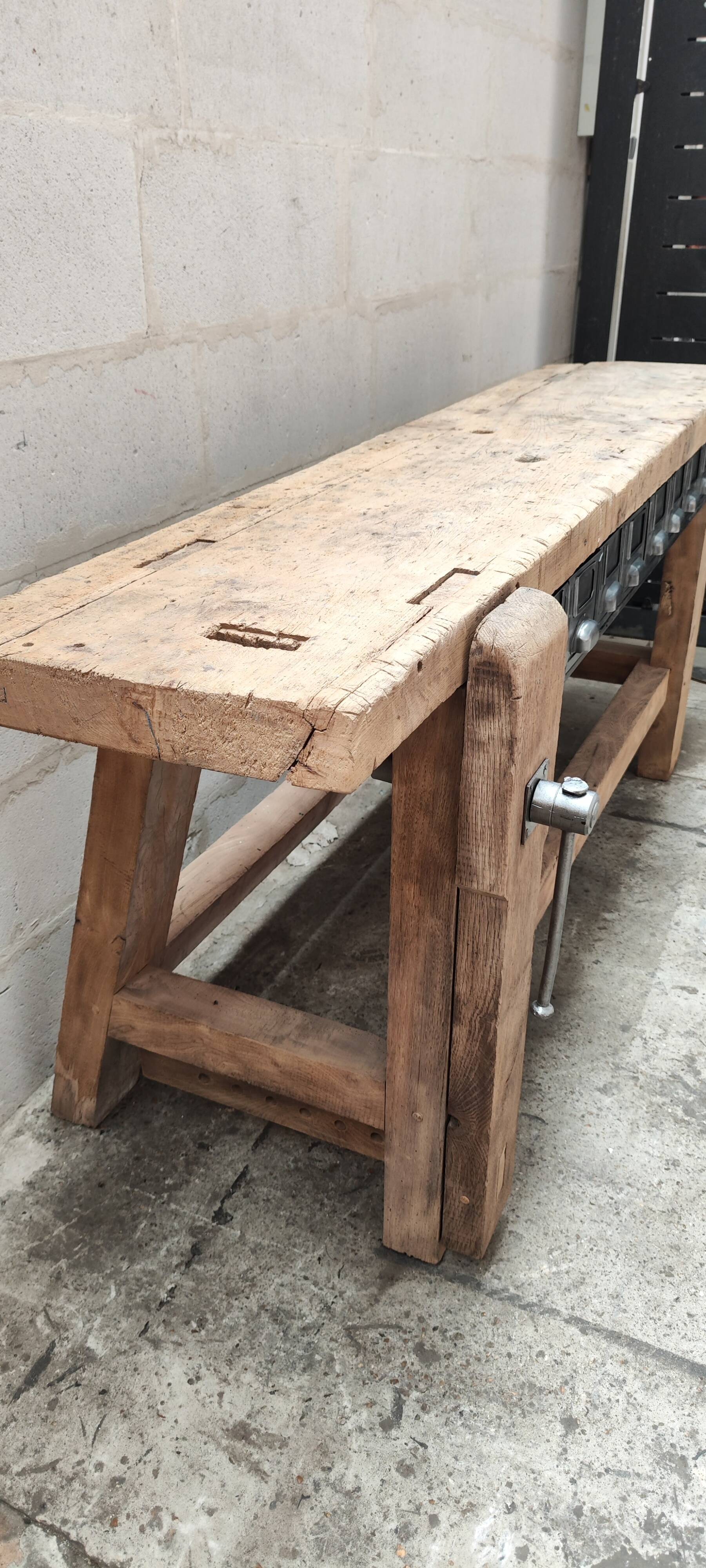 Old carpenter's workbench with eight metal drawers, industrial console