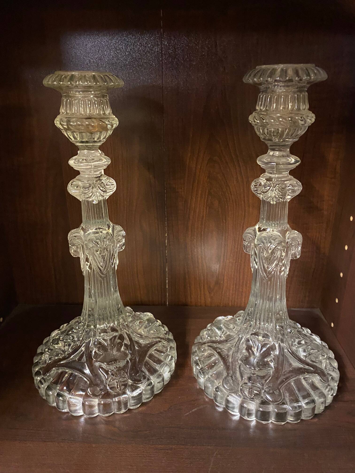 pair of cut glass candlesticks with lion and ram head decor, late 19th century