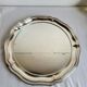 Round silver-plated serving dish with a glass base.