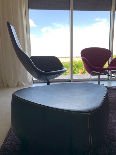 Moroso Fjord armchair with its pouf, design Patricia Urquiola 2002, steel and smooth black leather