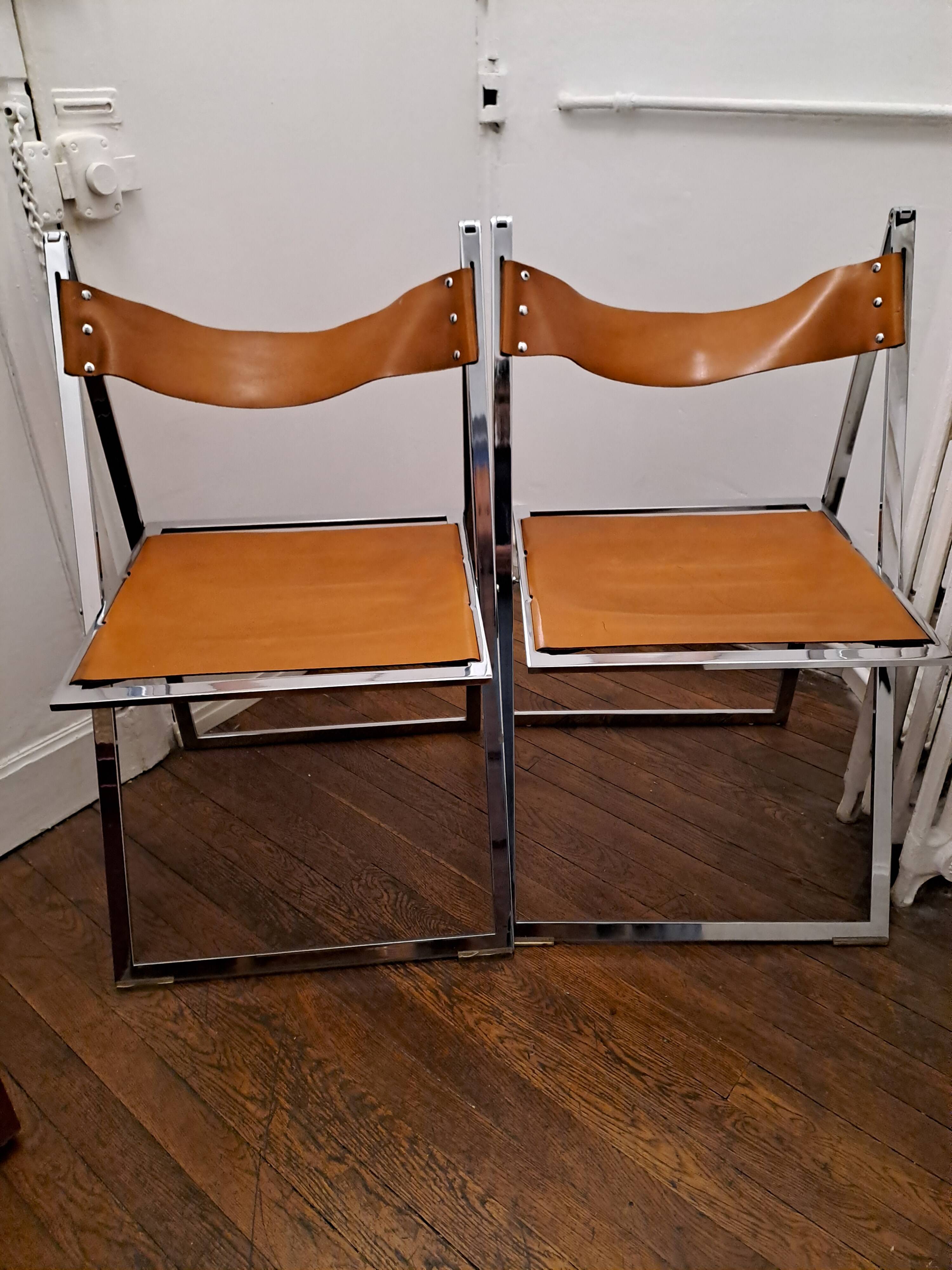 2 Chromed metal and leather folding chairs. 70s. Fontoni & Geraci