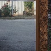 Wooden mirror decorated with gold from the 1920s