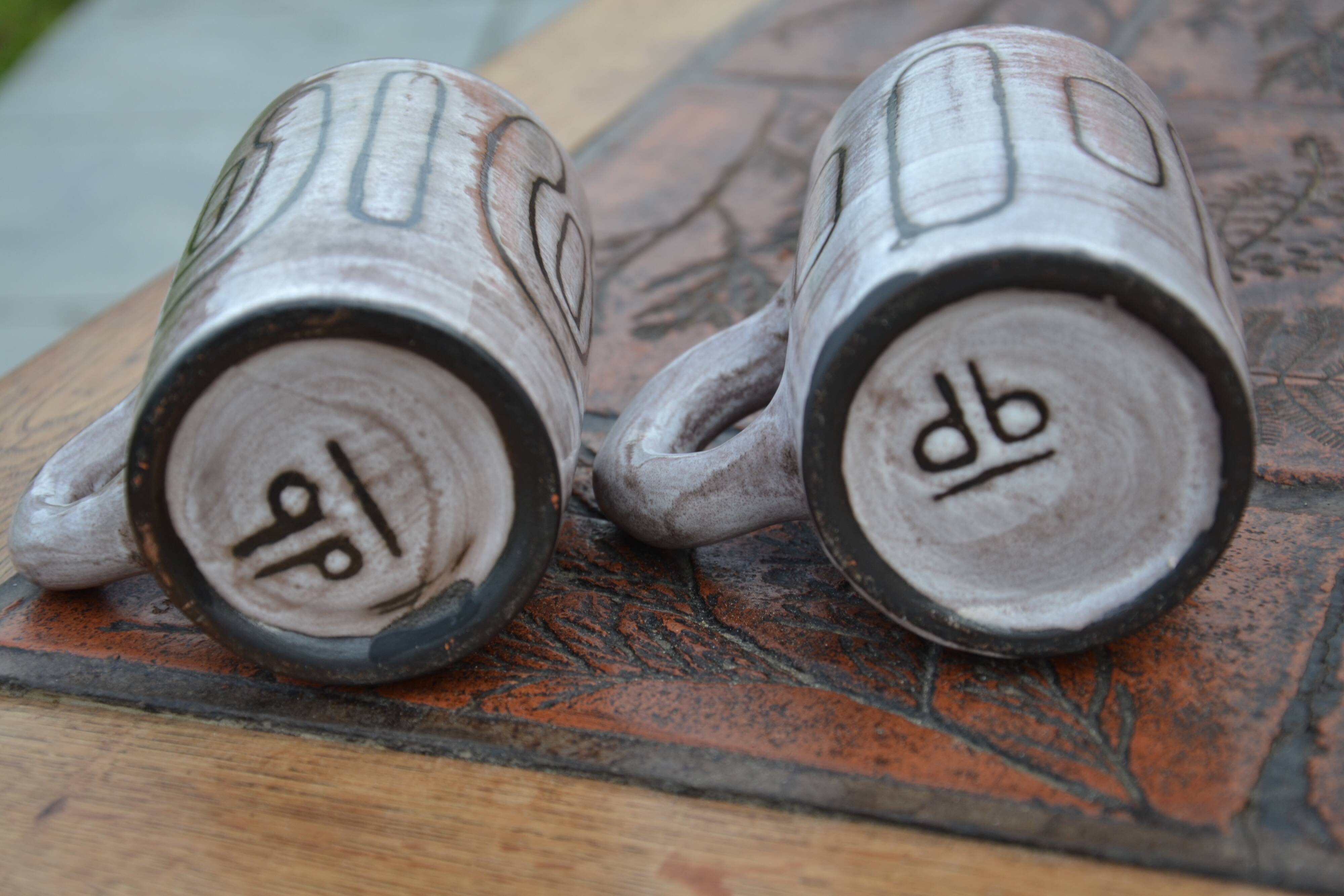 2 ceramic mugs signed db