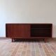 Teak enfilade, sliding doors, black faux leather top, 1970s.