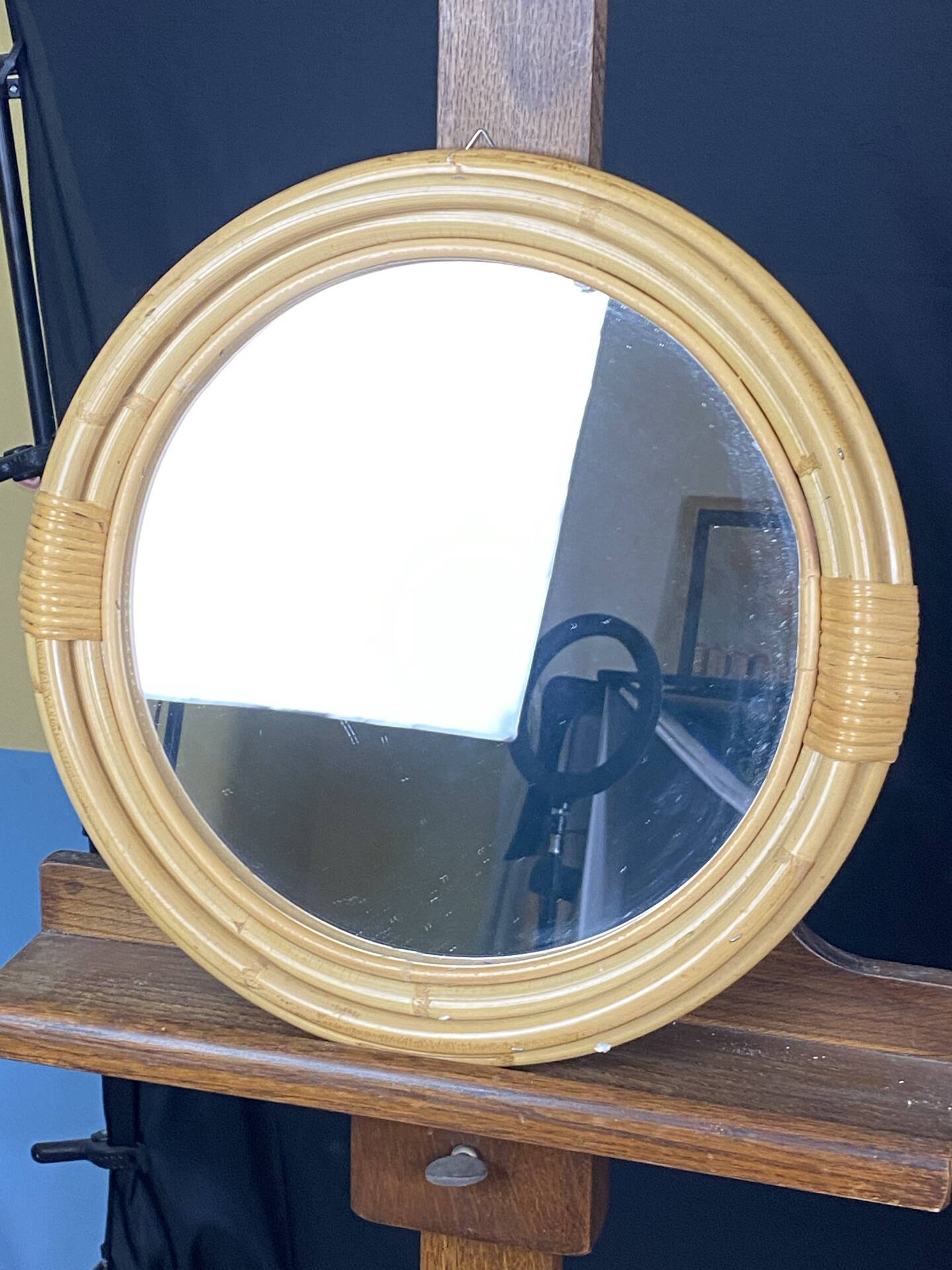 Round mirror from the 1960s with a frame made of rattan and metal.