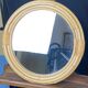 Round mirror from the 1960s with a frame made of rattan and metal.