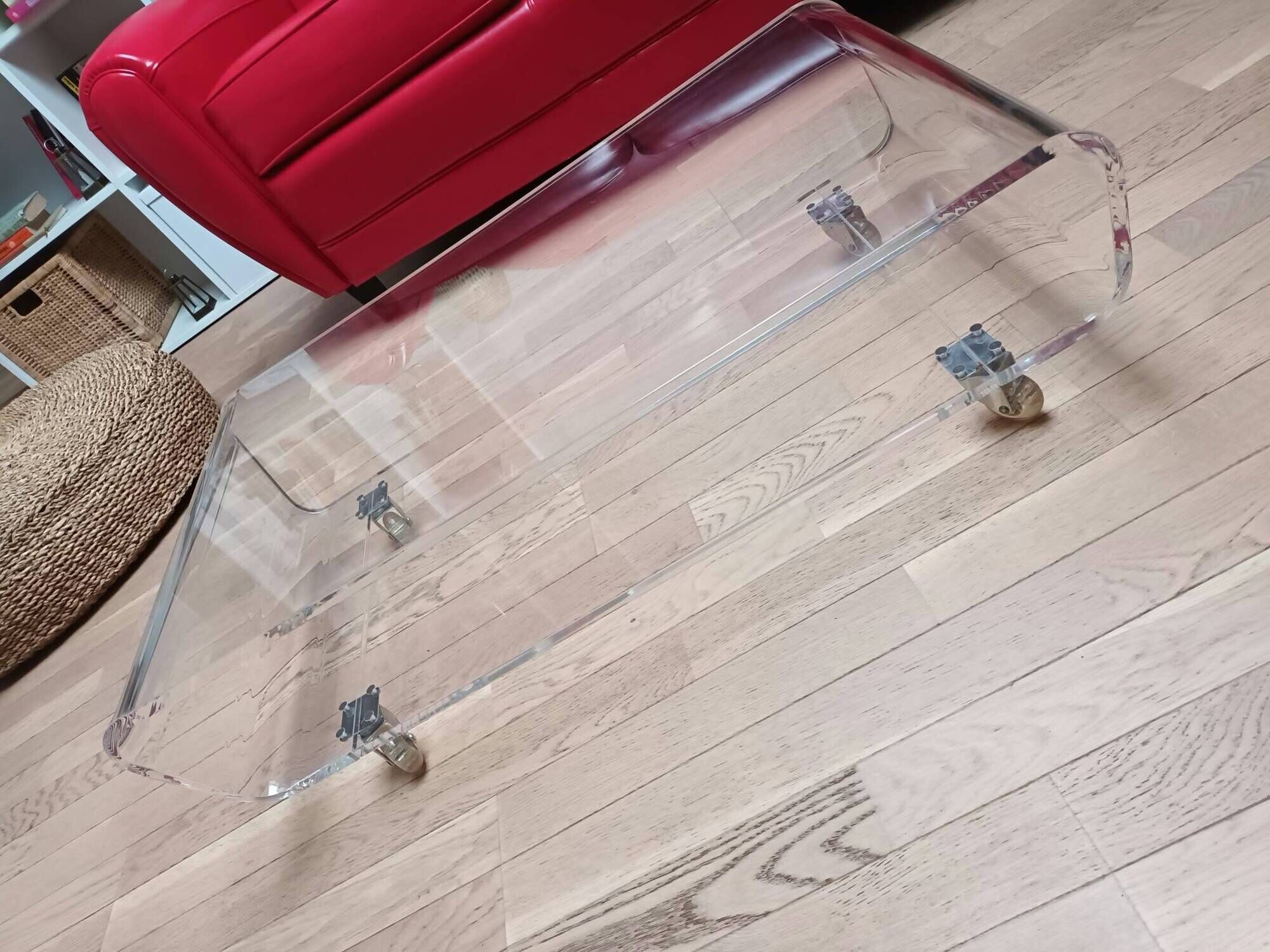 Design coffee table from Habitat in transparent plexiglass, mounted on wheels.