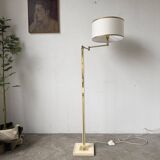 Floor lamp with articulated arm in brass-plated metal