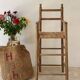 Old wooden high chair for children with a straw seat.