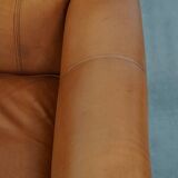 Cognac-colored cowhide leather armchair