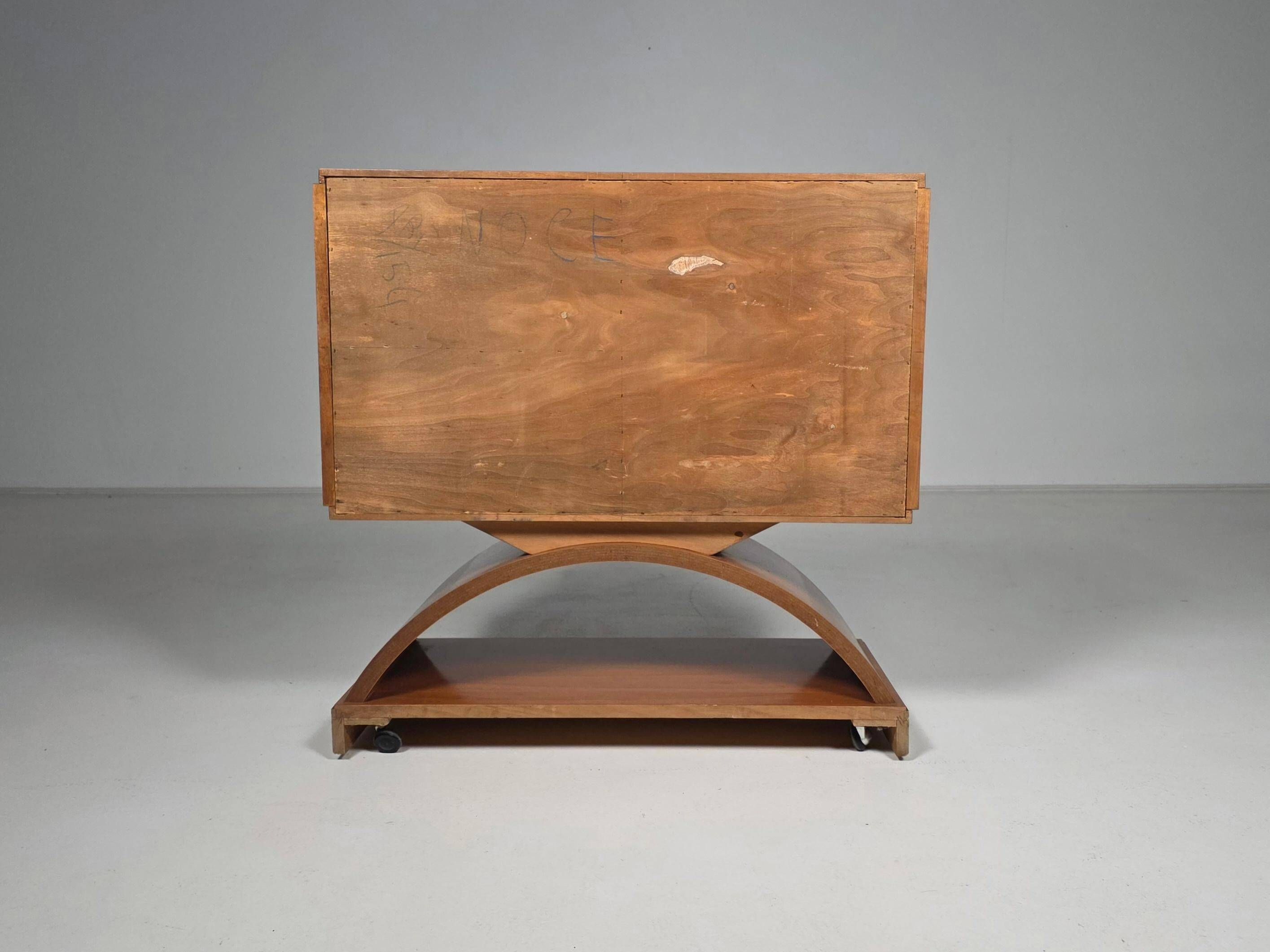 Mid-century modern mobile bar cabinet with sculptural base, 1950s.