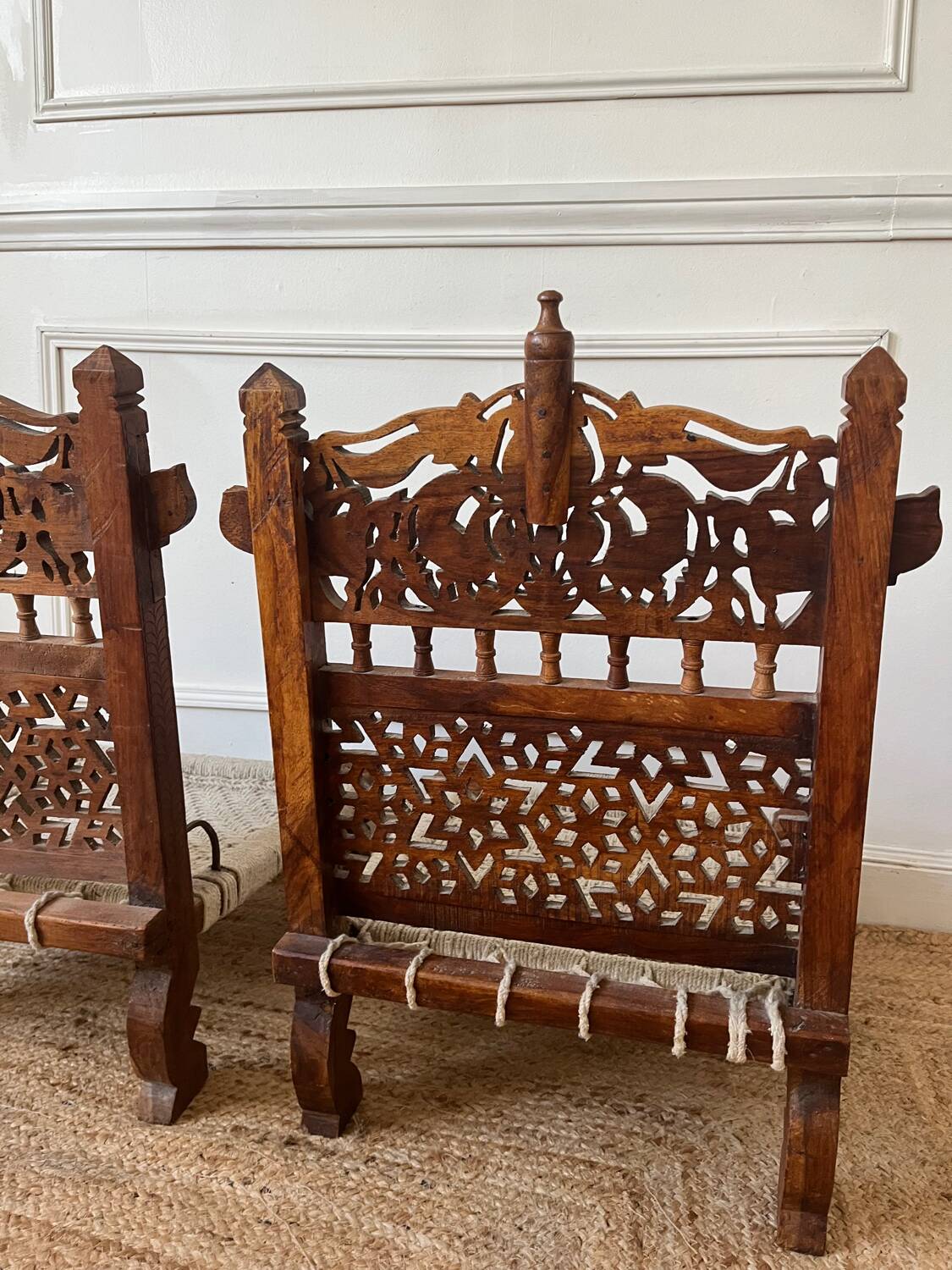 Pair of traditional Indian chairs made of carved wood and rope