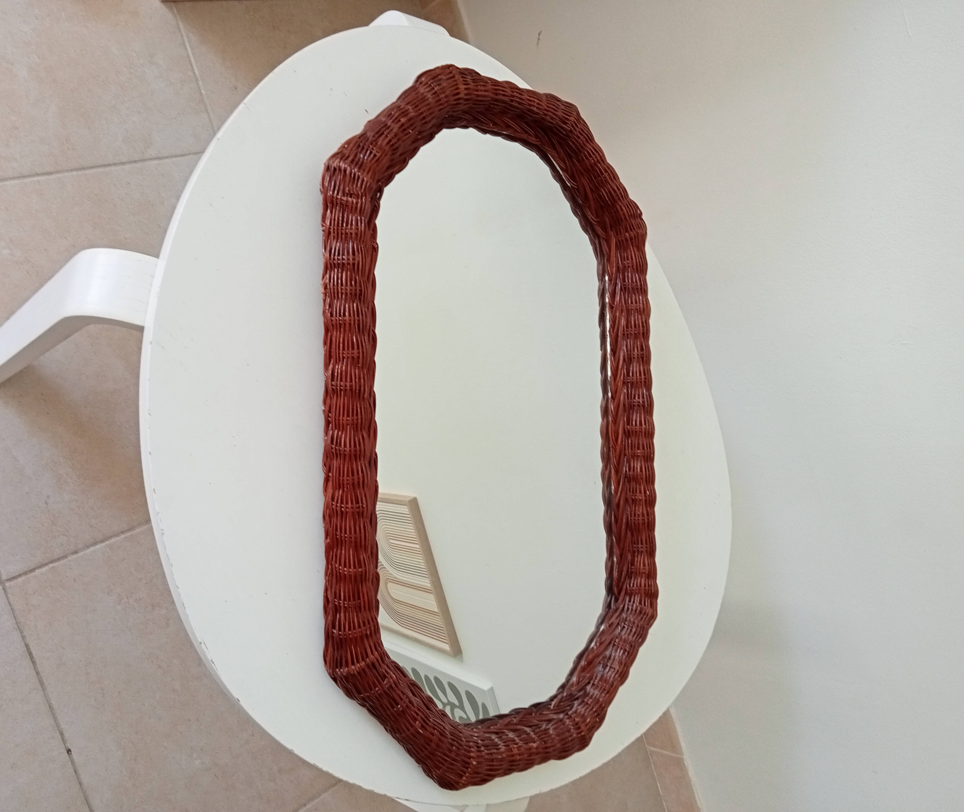 Vintage octagonal mirror in woven rattan.