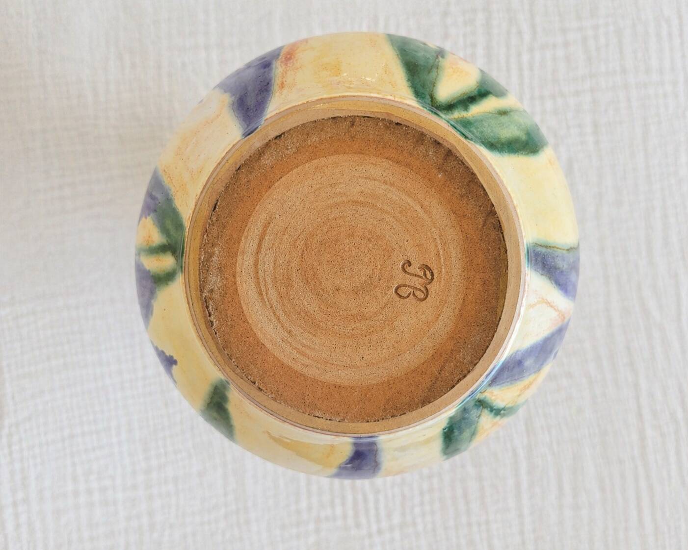 Hand-painted decorative vase with blue/purple irises.