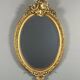 Oval gilded wooden mirror in Louis XV style, 19th century