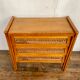 Modernist vintage chest of drawers in light chene has 3 drawers rattan top changing table