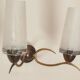 Two-light wall sconce in gilded metal with opaque glass shades, 1950/1960