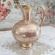 Chiseled brass pitcher decorated foliage