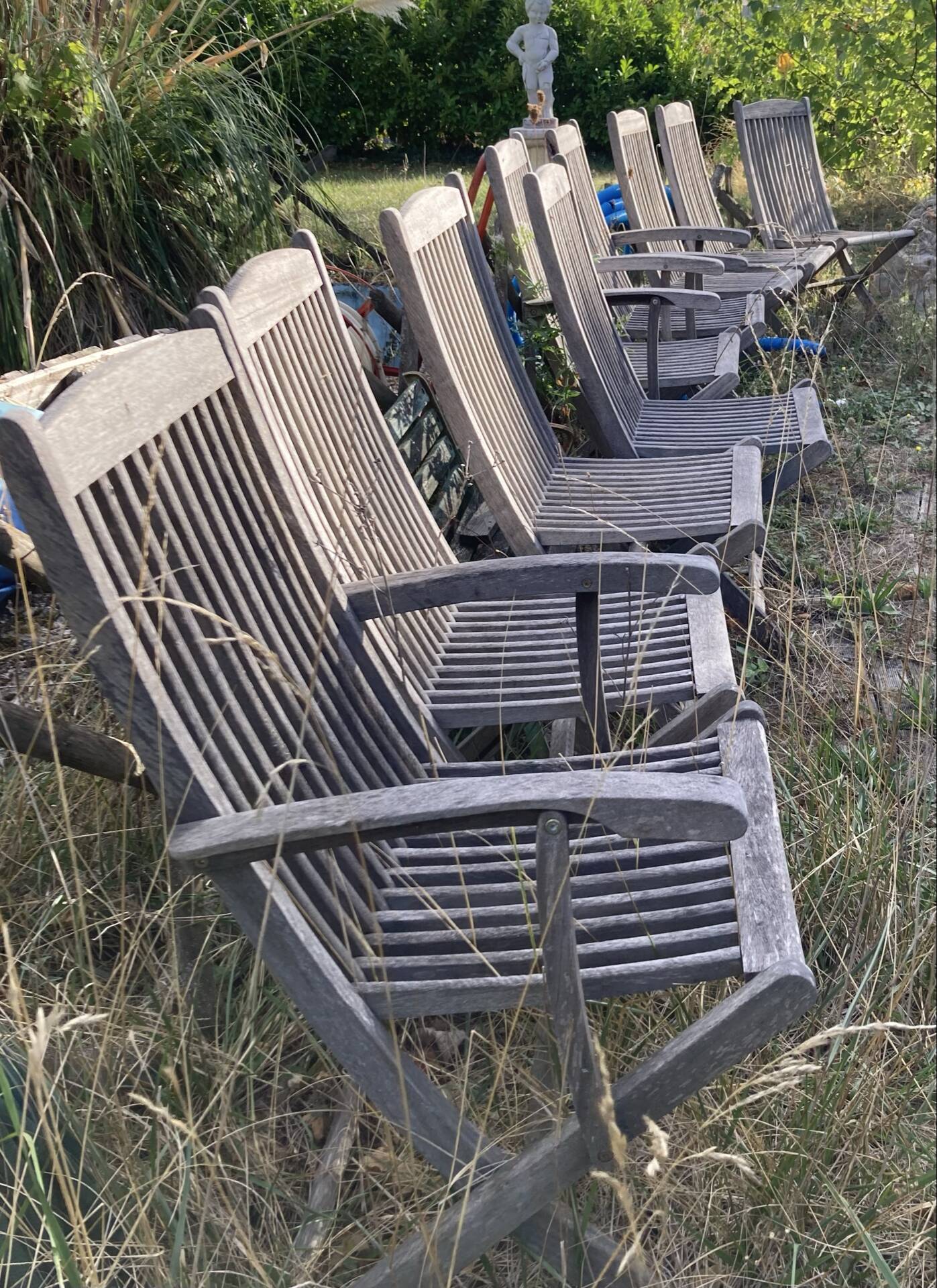Folding garden chairs and armchairs in River Han dowelled teak.