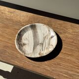 Tray, circular dish or plate made of white striped grey petrified wood.
