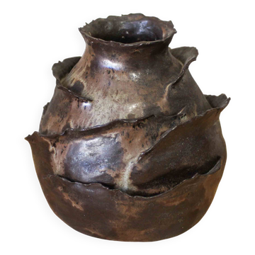 Glazed ceramic vase with petal decoration.