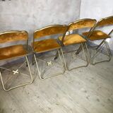 Four folding velvet and brass chairs